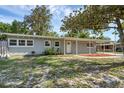 Charming single story home with welcoming front porch and a well-maintained yard under a clear sky at 807 E Airport Blvd, Sanford, FL 32773