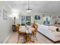 Cozy dining room with wood table adjacent to the living room and sliding glass doors at 1139 Seedorf Dr, Winter Haven, FL 33881