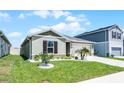 Well-maintained home featuring a green lawn with decorative rock and a two-car garage at 1139 Seedorf Dr, Winter Haven, FL 33881