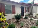 Charming home exterior with sidewalk, mulch landscaping, and neutral colored stucco at 13 W Marbrisa Way, Kissimmee, FL 34743