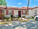 Charming single story house with painted facade, decorative shutters, and tidy landscaping at 13 W Marbrisa Way, Kissimmee, FL 34743