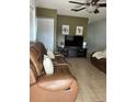 Inviting living room with modern ceiling fan, and comfortable leather seating at 13 W Marbrisa Way, Kissimmee, FL 34743