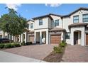 Inviting townhome with a brick driveway and private garage at 1312 Royal St George Blvd, Davenport, FL 33896
