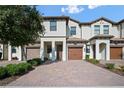 Attractive townhome with brick driveway, front garage and covered entryway at 1312 Royal St George Blvd, Davenport, FL 33896