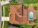 Aerial view of the home showcasing the roof, patio, pool area, landscaping, and proximity to neighbors at 13130 Meergate Cir, Orlando, FL 32837