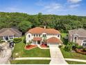 Aerial view of the home showing manicured lawn and landscaping. Close to a wooded area for added privacy at 13130 Meergate Cir, Orlando, FL 32837