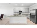 Modern kitchen featuring granite countertops, stainless steel appliances, and a central island at 172 Roseville Dr, Haines City, FL 33844