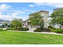 Well-manicured lawn and garden surrounding a quaint two-story home at 1801 Coastal Ct, Celebration, FL 34747