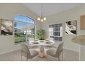 Cozy breakfast nook featuring a round table with seating for four and a large window overlooking the yard at 231 Lewis Dr, Davenport, FL 33837