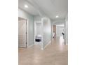 Bright hallway featuring tile floors, and an arched doorway at 2416 White Poppy Dr, Kissimmee, FL 34747