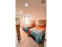 Twin bedroom with colorful bedding, a mirror, and natural light at 3014 Red Ginger Rd, Kissimmee, FL 34747