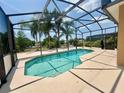 Screened-in pool featuring clear blue water and a spacious deck area at 315 Wildflower Rd, Davenport, FL 33837