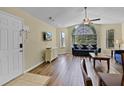 Bright living room with a large window, ceiling fan, and wood floors, creating a comfortable and stylish space at 3151 Britannia Blvd # C, Kissimmee, FL 34747