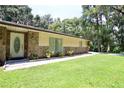 Home showcasing a decorative front door with stone detailing and window accents at 860 Oak Shore Dr, St Cloud, FL 34771