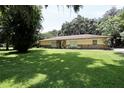 Inviting single story home with stone accents and lush green lawn at 860 Oak Shore Dr, St Cloud, FL 34771