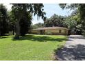 Traditional home boasts a well-maintained lawn and an asphalt driveway at 860 Oak Shore Dr, St Cloud, FL 34771