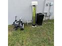 Side view of the house, showing the water filtration system at 1210 Zambrana Ct, Winter Haven, FL 33884