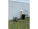 Side view of the house, showing the water filtration system at 1210 Zambrana Ct, Winter Haven, FL 33884