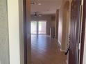 Spacious living room with tile floors, ceiling fan and sliding door access to the backyard at 13620 Cepheus Dr, Orlando, FL 32828