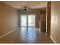 Bright living room with neutral walls, tile flooring, and sliding glass doors to the patio at 13620 Cepheus Dr, Orlando, FL 32828