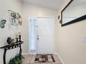 Bright foyer featuring tile flooring, decorative accents, and a welcoming atmosphere at 1364 Rebecca Dr, Haines City, FL 33844