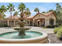 Beautiful clubhouse entrance features a fountain, manicured landscaping, and Mediterranean-style architecture at 1375 Tuscana Ln # 1405, Davenport, FL 33896