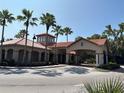 A beautiful entrance featuring palm trees, and a tower adorned with elegant arched windows at 1375 Tuscana Ln # 1405, Davenport, FL 33896