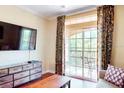 Cozy living room with balcony access offering scenic views and natural light with stylish decor at 1375 Tuscana Ln # 1405, Davenport, FL 33896