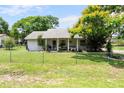 Attractive single-story home boasts a green lawn, fenced yard and mature landscaping at 1640 Marks St, Kissimmee, FL 34746