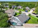 Aerial view of a neighborhood featuring a screened pool and beautiful green landscaping at 1851 Hammock Moss Dr, Orlando, FL 32820