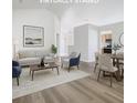 Bright, staged living room featuring hardwood floors and neutral-colored furniture at 1851 Hammock Moss Dr, Orlando, FL 32820