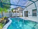 Relaxing screened-in pool with a blue-tile trim and a view of the backyard at 1851 Hammock Moss Dr, Orlando, FL 32820