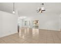 Spacious living room featuring tile floors, ceiling fan, and sliding glass doors at 1914 Ellery Ln, Kissimmee, FL 34746