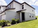 Well-kept two-story home exhibiting neat landscaping and a covered front entrance at 2086 Crape Jasmine Ln, Orlando, FL 32824