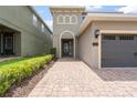 Attractive two-story home featuring a brick paver driveway and well-maintained lawn at 340 Pendant Ct, Kissimmee, FL 34747