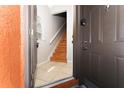 Inviting entryway featuring tile flooring and a staircase leading to the upper level at 437 Fountainhead Cir # 283, Kissimmee, FL 34741