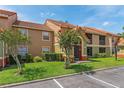 Inviting condo complex featuring well-maintained landscaping and ample parking at 437 Fountainhead Cir # 283, Kissimmee, FL 34741