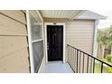 Exterior shot of unit's front door, showing the unit number and the surrounding structure at 4728 Walden Cir # 32, Orlando, FL 32811
