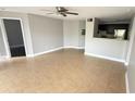 Bright living room featuring tile floors, ceiling fan, and a view into the kitchen at 4728 Walden Cir # 32, Orlando, FL 32811