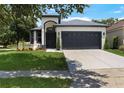 Charming two-story home featuring a manicured lawn, two car garage, and attractive front door and trim at 4903 Santa Clara Dr, Orlando, FL 32837