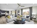 Sun-lit open concept living room with contemporary furnishings and stylish decor at 5159 Kinsley Dr, Lake Wales, FL 33859
