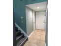 Inviting entryway with tiled flooring, stairway, and a white door, offering a glimpse into the home at 5826 Peregrine Ave # F01, Orlando, FL 32819