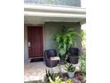 Cozy patio area featuring wicker seating, potted plants, and a welcoming entrance with seasonal decorations at 5826 Peregrine Ave # F01, Orlando, FL 32819