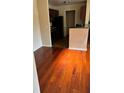 Open floor plan featuring hardwood floors flowing from the living area into the partially visible kitchen at 6148 Westgate Dr # 302, Orlando, FL 32835