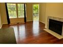 Well-lit living room with hardwood floors, fireplace and large windows that offer outside views at 6148 Westgate Dr # 302, Orlando, FL 32835