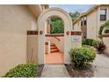 Arched entry and stairs leading to a townhome front door at 7667 Sugar Bend Dr # 7667, Orlando, FL 32819