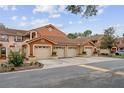 Street view of townhomes with terra cotta colored walls and tile roofs at 7667 Sugar Bend Dr # 7667, Orlando, FL 32819