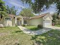 Well-maintained home featuring lush landscaping, a two-car garage, and a classic suburban appeal at 86 Blackberry Creek Dr, St Cloud, FL 34769