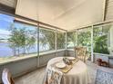 Inviting enclosed patio with views of a serene lake surrounded by mature bamboo at 86 Blackberry Creek Dr, St Cloud, FL 34769
