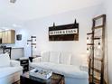 Comfortable living room with white sofa, rustic decor, and wood-look flooring at 9055 Treasure Trove Ln # 207, Kissimmee, FL 34747
